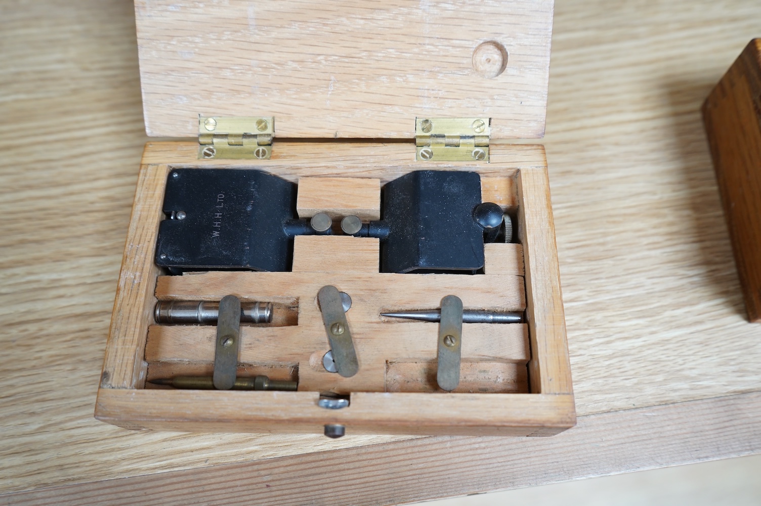 A early 20th century boxed 52 inch, draughtsman’s beam compasses, Mk.II, together with two oak boxes of fittings, all three boxes stamped with; ‘ COMPASSES BEAM 52-IN Mk.II’, and an early 20th century German leather case